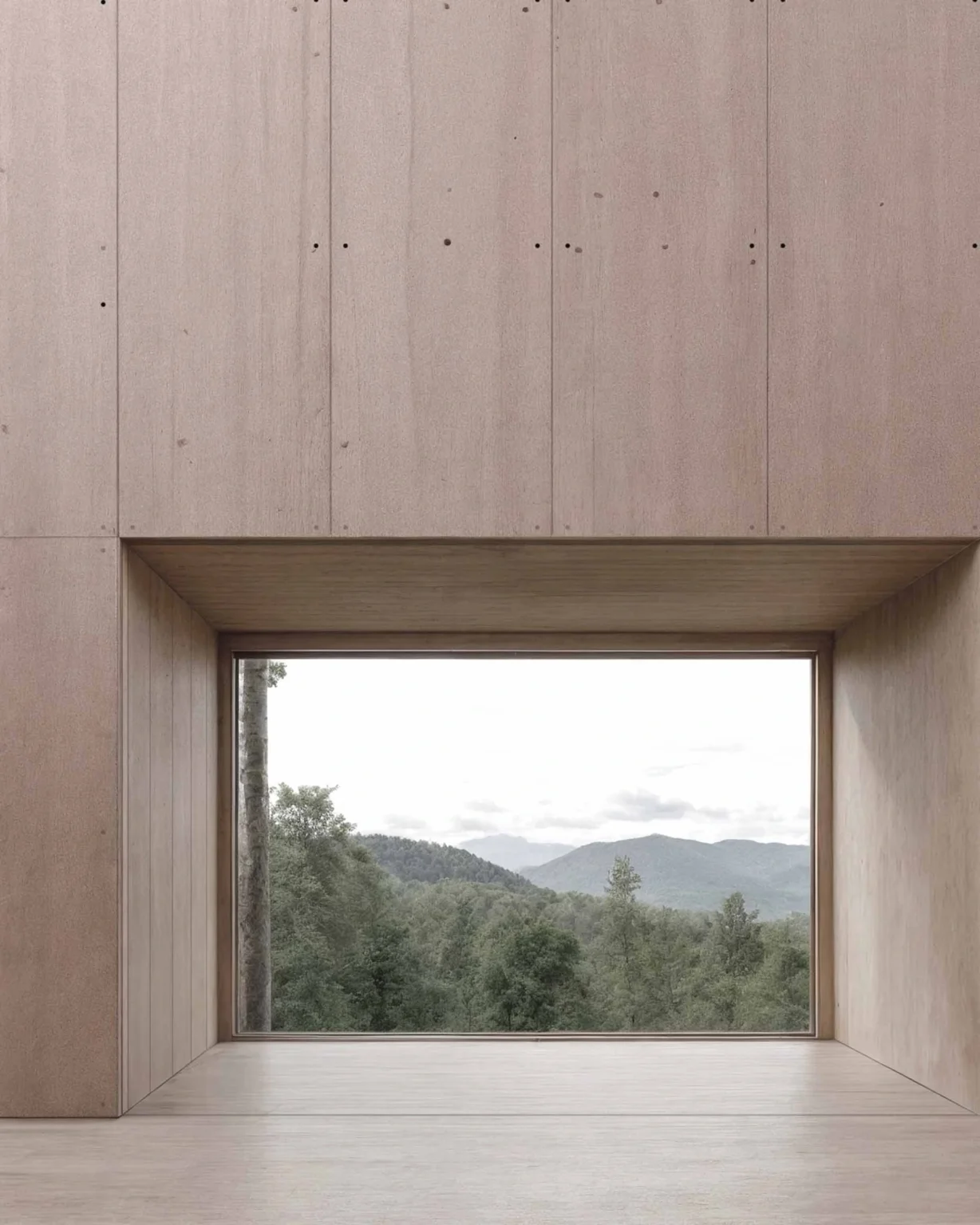 Baie panoramique encadrée de contreplaqué donnant sur un paysage forestier et montagneux, architecture rurale moderne et contemporaine conçue par Arthur Montessuit, Architecte en Haute-Savoie.